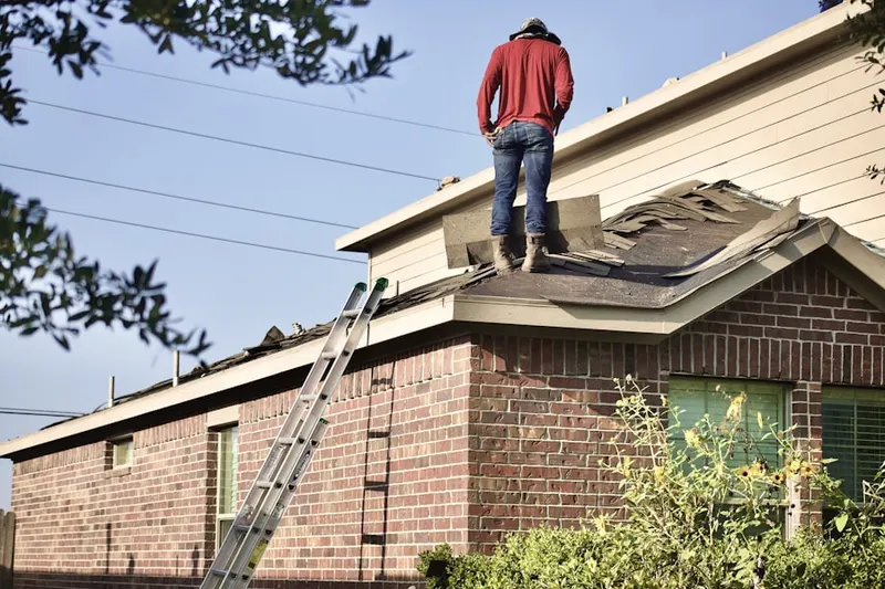 Professional roofer working on a residential roof in Don Scott